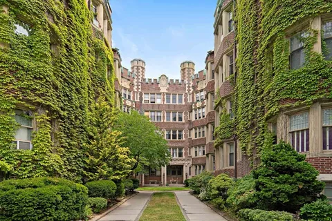 a view of a brick building next to a yard