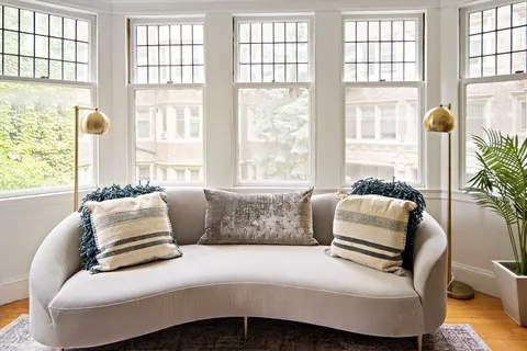 a bedroom with a bed and glass window
