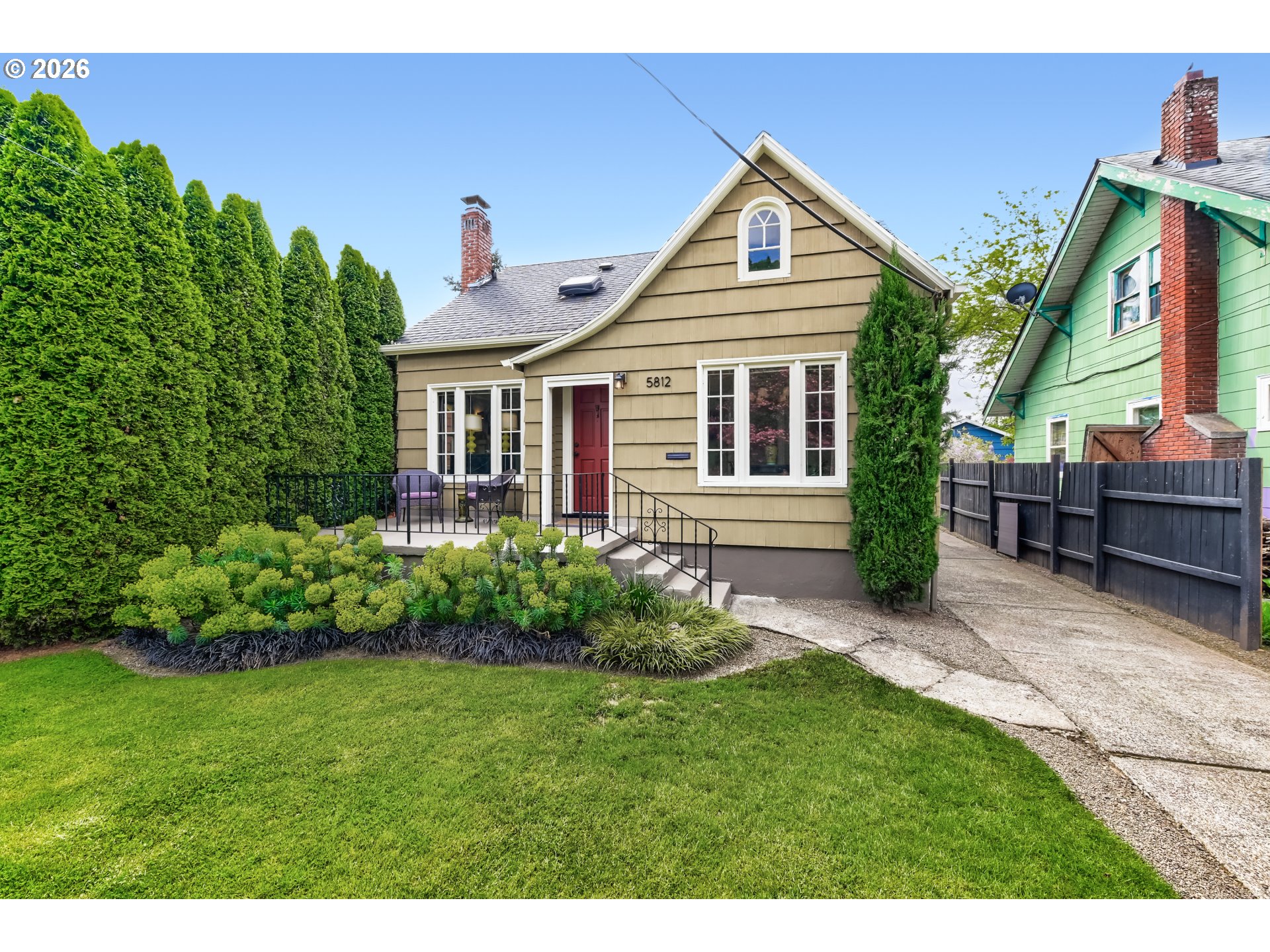 5812 Southeast Bush Street Portland, OR 97206 - Photo 1 of 27 a front view of a house with a yard