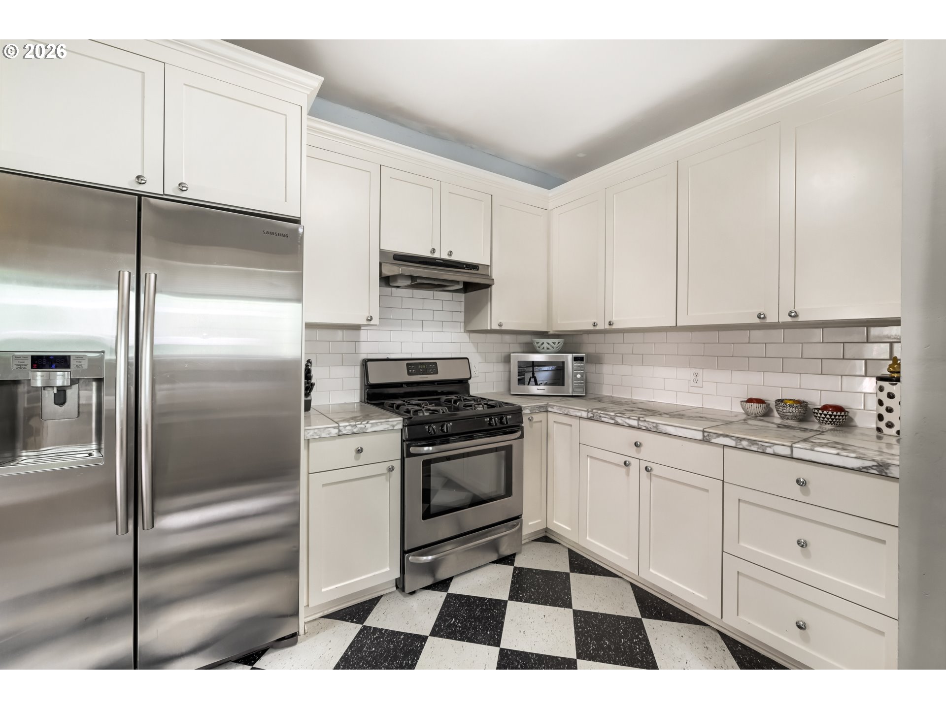 5812 Southeast Bush Street Portland, OR 97206 - Photo 14 of 27 a kitchen with granite countertop stainless steel appliances and cabinets