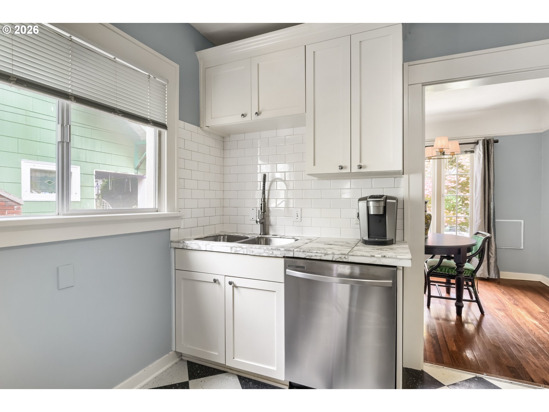 5812 Southeast Bush Street Portland, OR 97206 - Photo 15 of 27 a kitchen with a sink cabinets and dining table