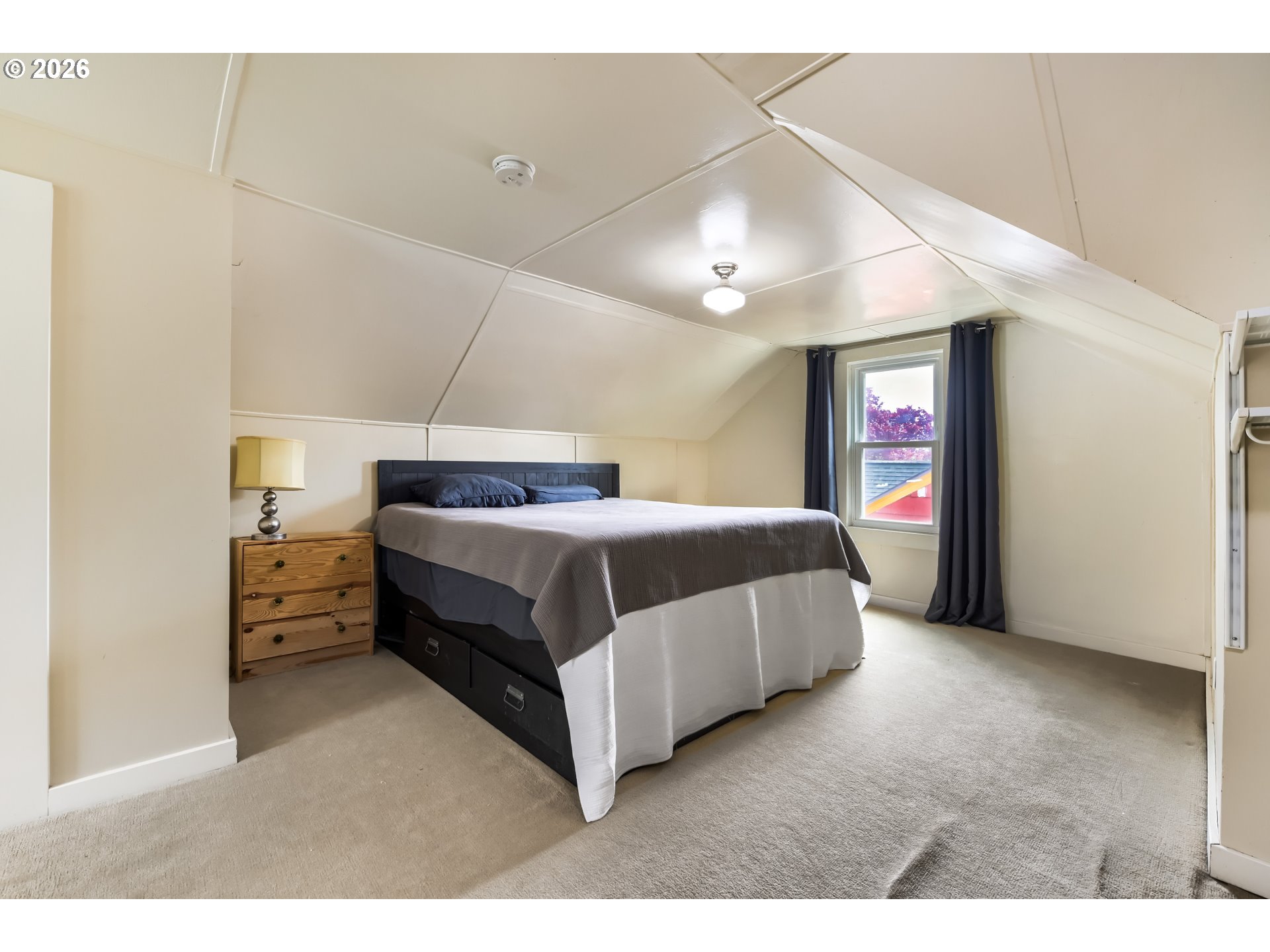 5812 Southeast Bush Street Portland, OR 97206 - Photo 19 of 27 a spacious bedroom with a bed and a cabinets