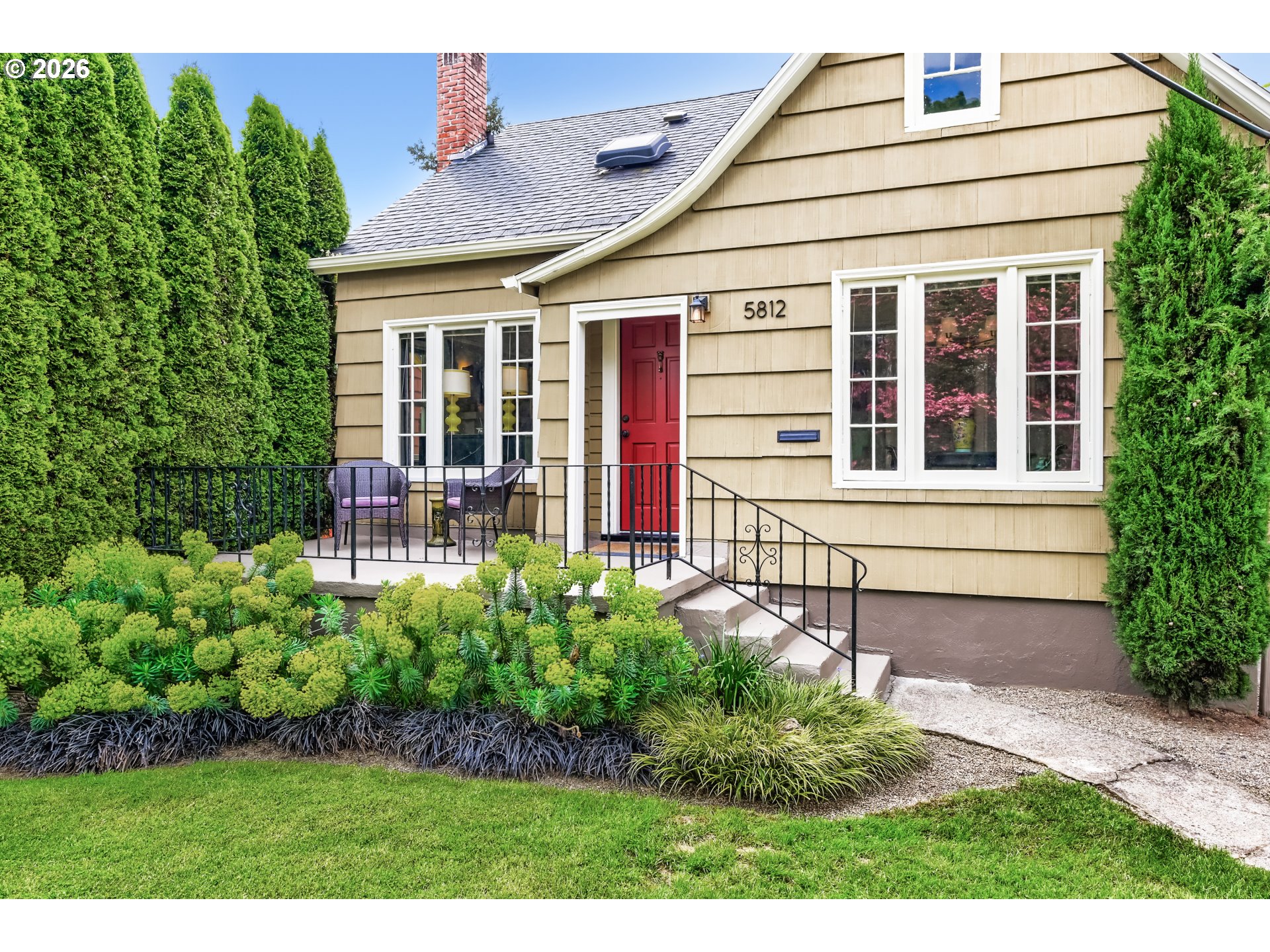 5812 Southeast Bush Street Portland, OR 97206 - Photo 2 of 27 a front view of a house with garden