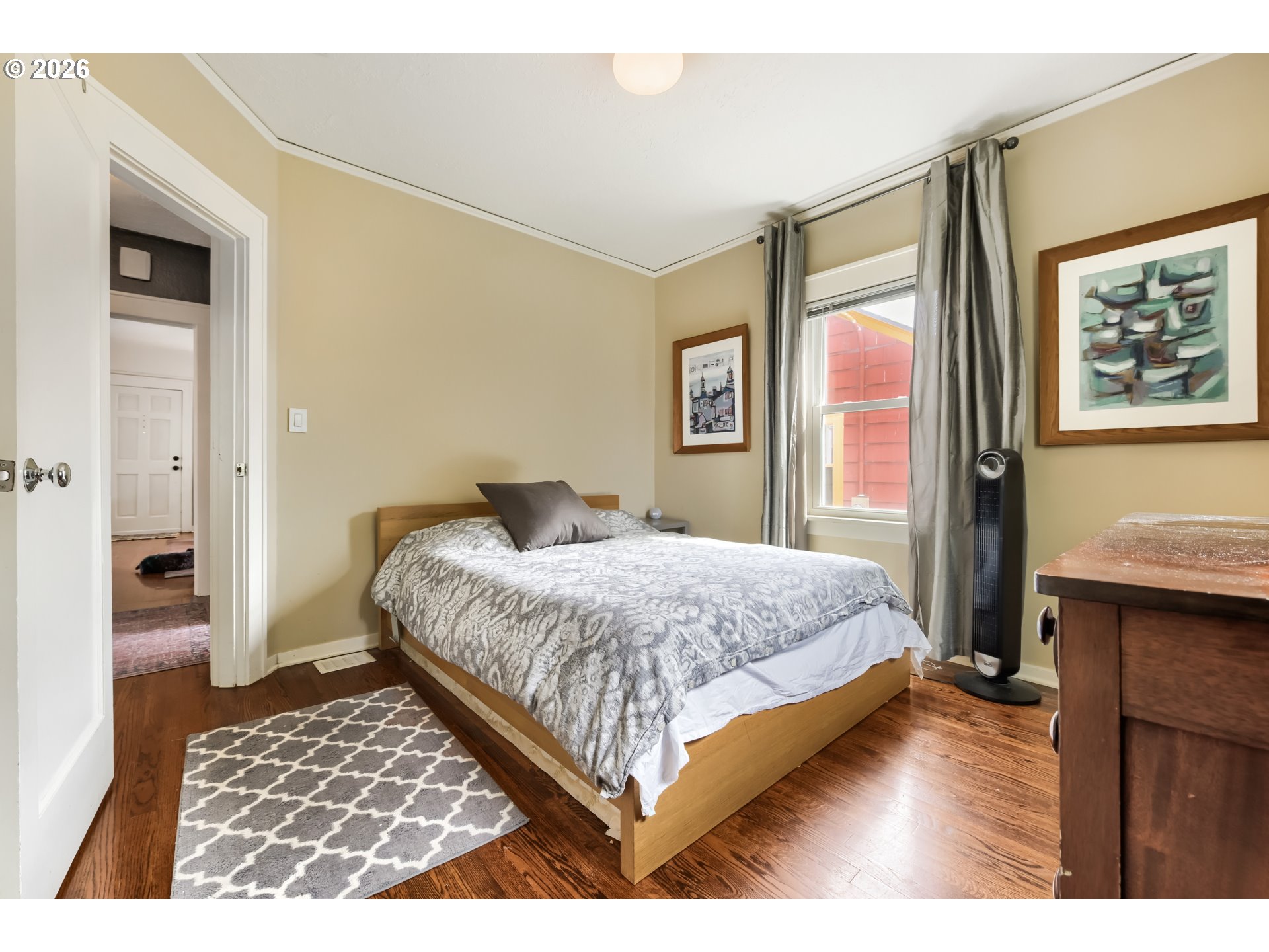 5812 Southeast Bush Street Portland, OR 97206 - Photo 21 of 27 a bedroom with a bed wooden floor and a table