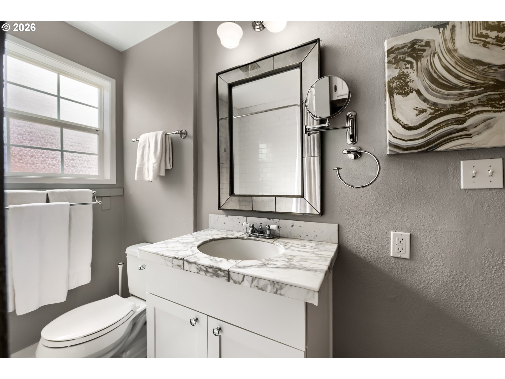 5812 Southeast Bush Street Portland, OR 97206 - Photo 23 of 27 a bathroom with a granite countertop toilet sink and mirror