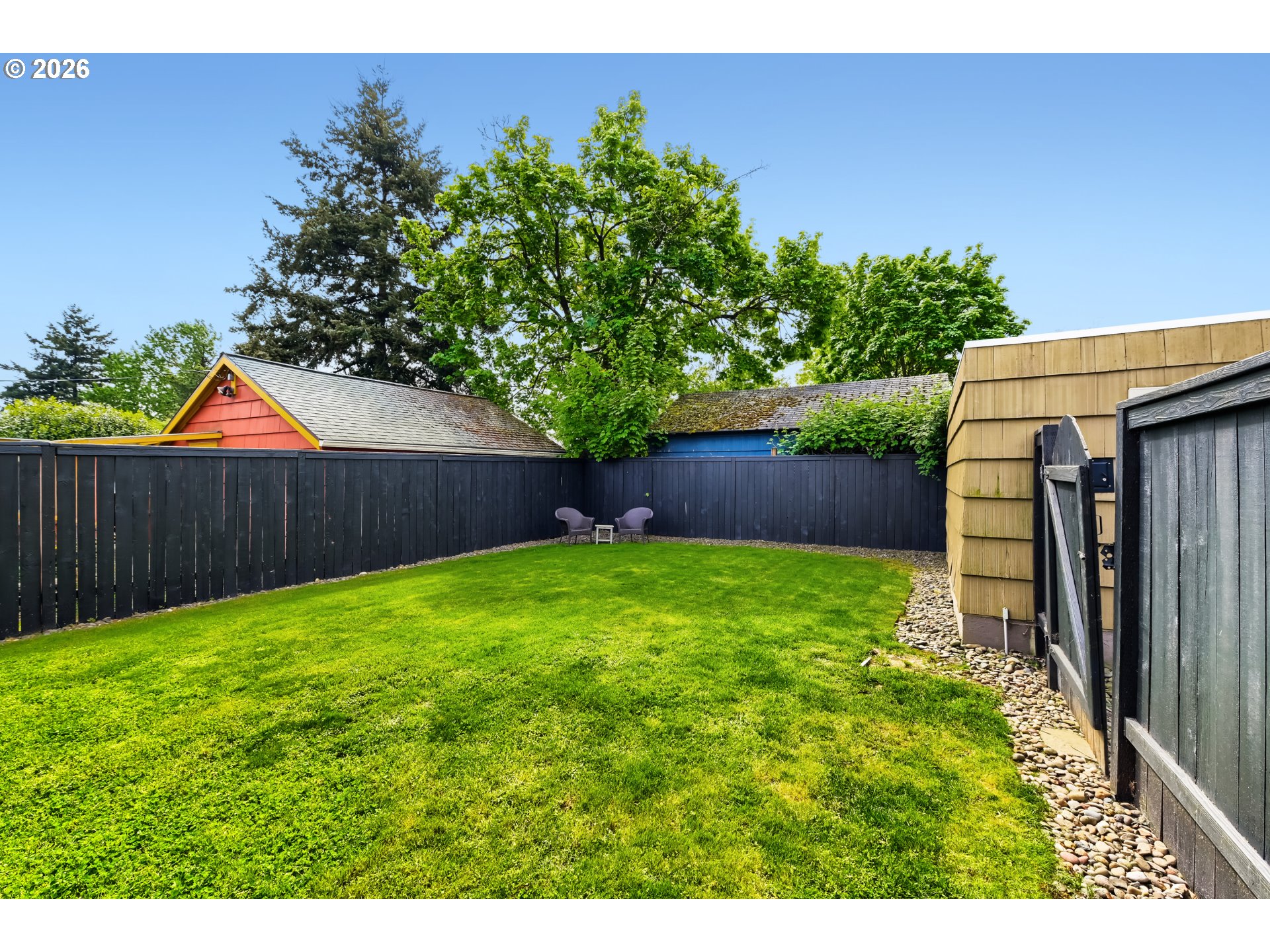 5812 Southeast Bush Street Portland, OR 97206 - Photo 26 of 27 a view of backyard with potted plants and wooden fence