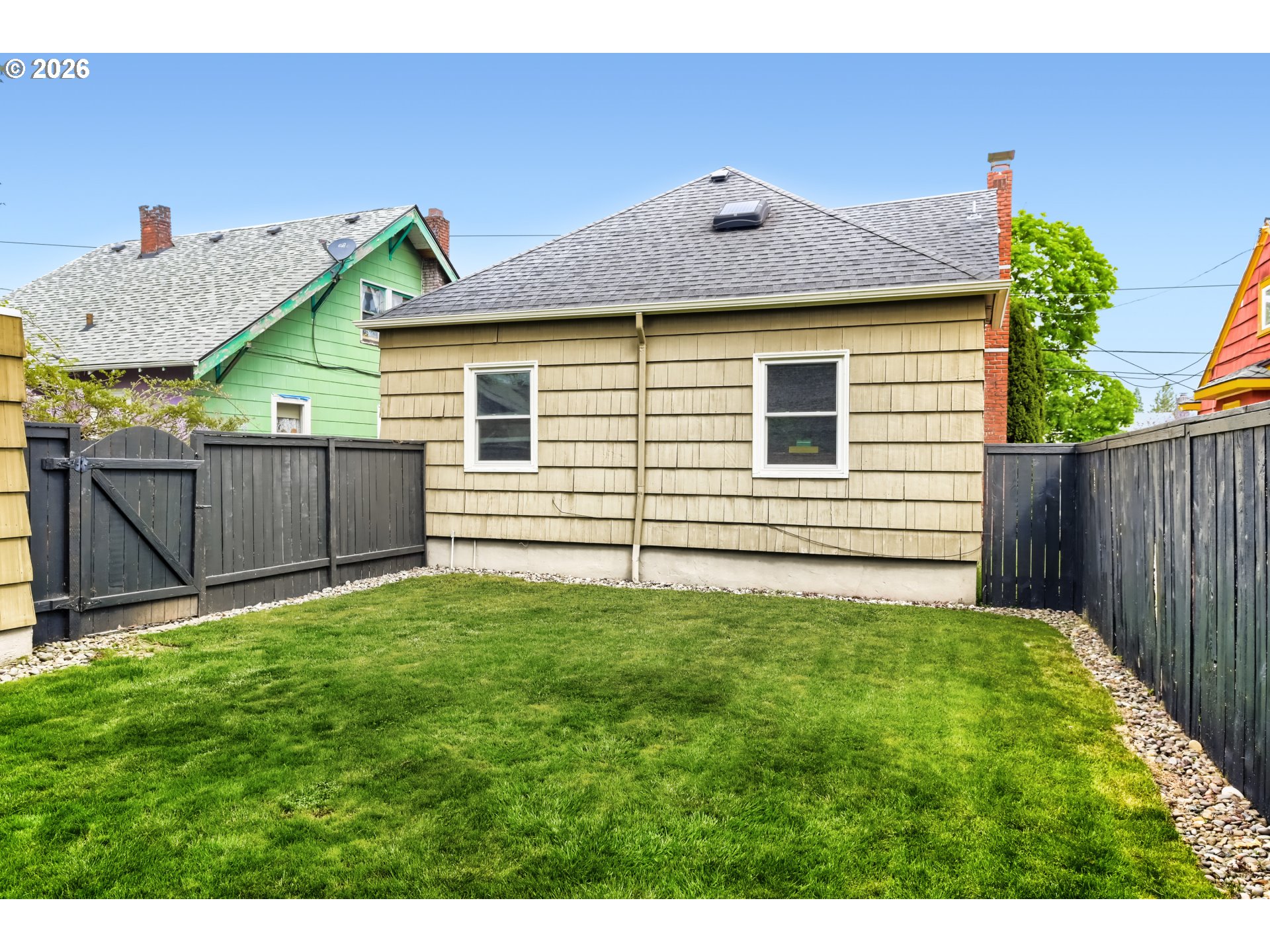 5812 Southeast Bush Street Portland, OR 97206 - Photo 27 of 27 a view of a house with backyard and wooden fence