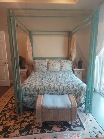 a bed sitting in a room next to a window