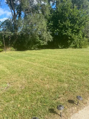 a view of a brick house with a yard