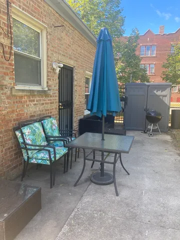 a brick building with a bench in front of door