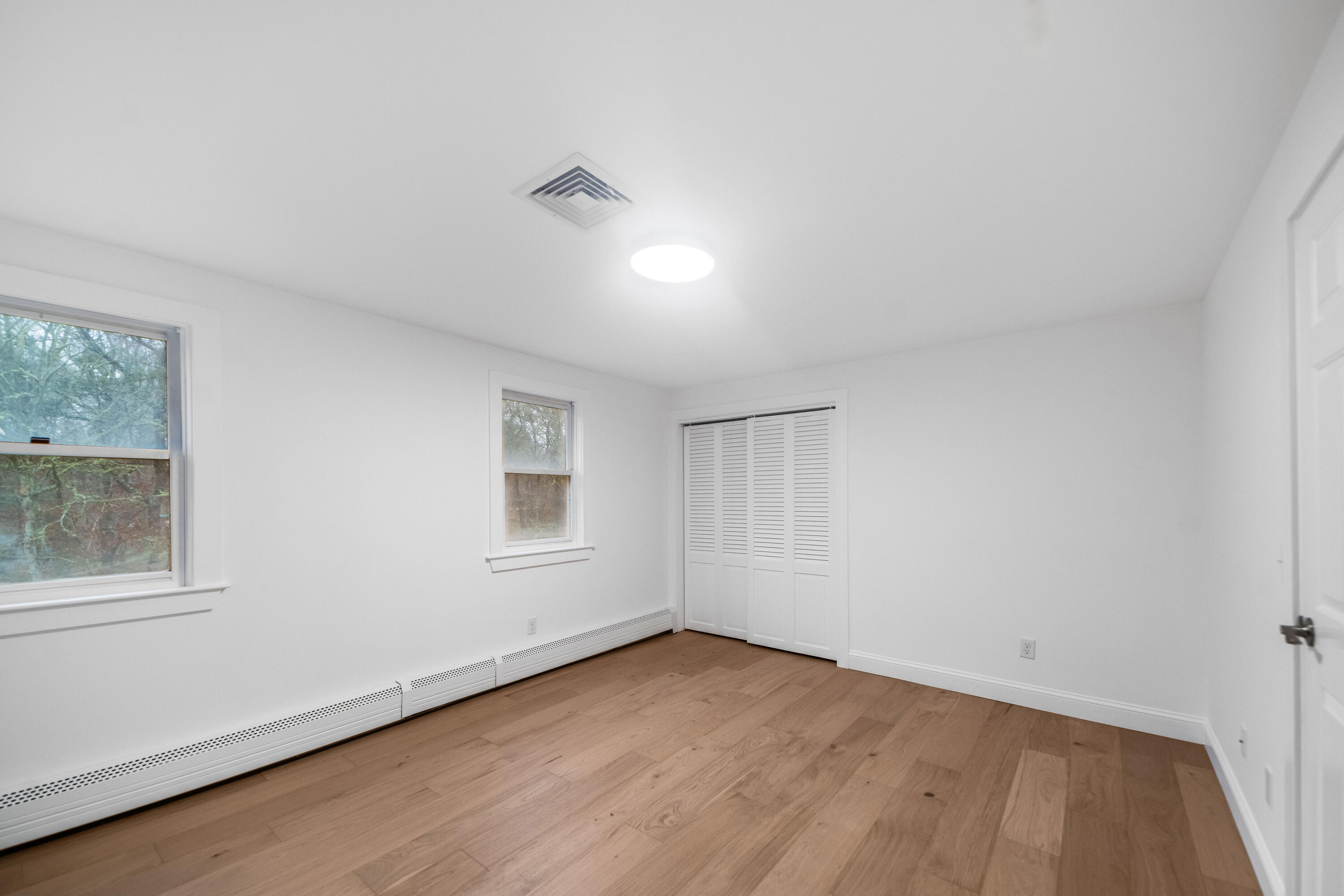 3 Sheayer Road Harwich, MA 02645 - Photo 28 of 38 an empty room with wooden floor and windows