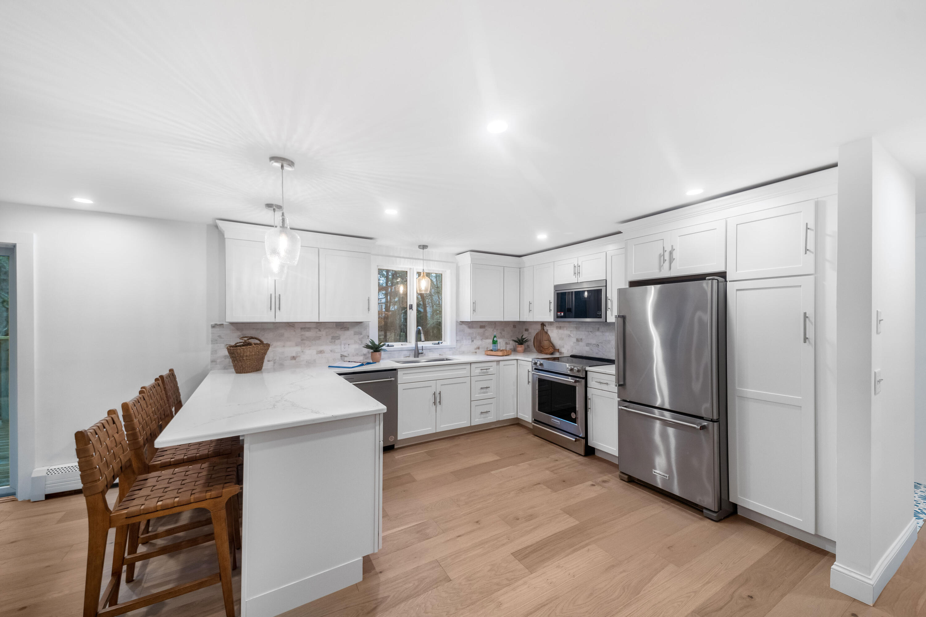 3 Sheayer Road Harwich, MA 02645 - Photo 5 of 38 a kitchen with white cabinets and stainless steel appliances