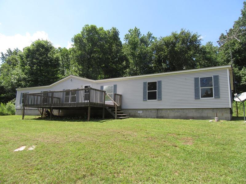 2153 Broome Road Palmyra, TN 37142 - Photo 1 of 10 a house that has a big yard with wooden fence