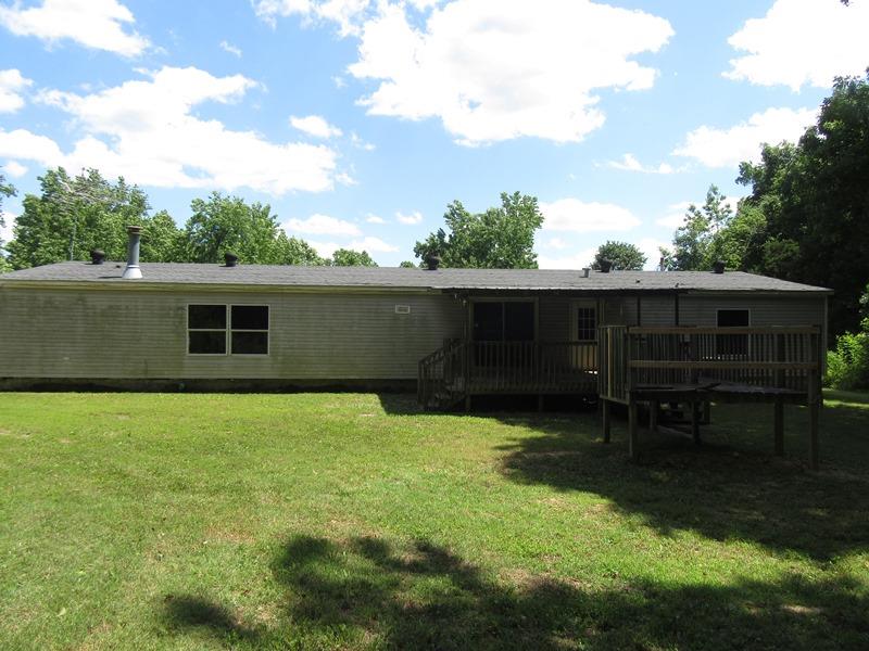 2153 Broome Road Palmyra, TN 37142 - Photo 2 of 10 a backyard of a house with table and chairs