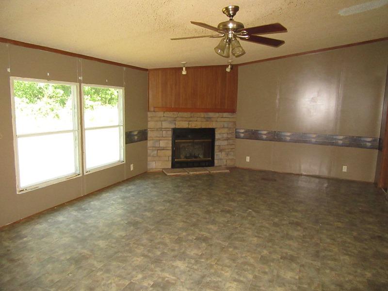 2153 Broome Road Palmyra, TN 37142 - Photo 5 of 10 an empty room with windows and fireplace