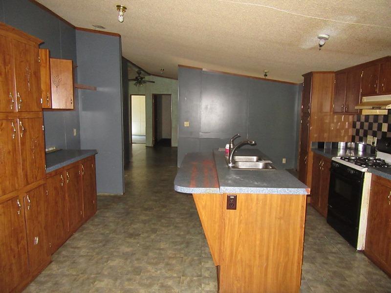 2153 Broome Road Palmyra, TN 37142 - Photo 6 of 10 a kitchen with sink a refrigerator and cabinets