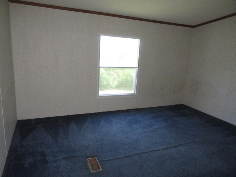 2153 Broome Road Palmyra, TN 37142 - Photo 8 of 10 an empty room with a window