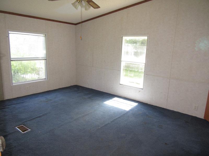2153 Broome Road Palmyra, TN 37142 - Photo 9 of 10 an empty room with windows and chandelier fan