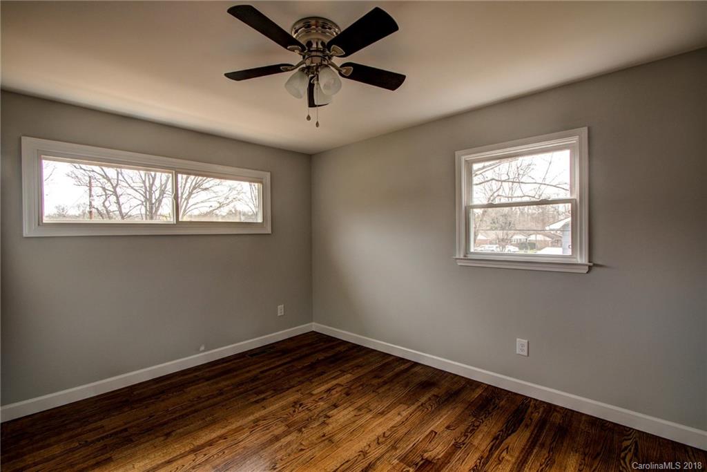 7624 Watercrest Road Charlotte, NC 28210 - Photo 22 of 31 a view of empty room with wooden floor and fan