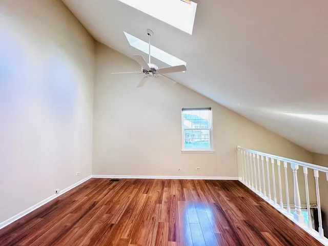 a view of a room with wooden floor closet and windows