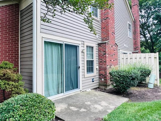 a view of a house with potted plants