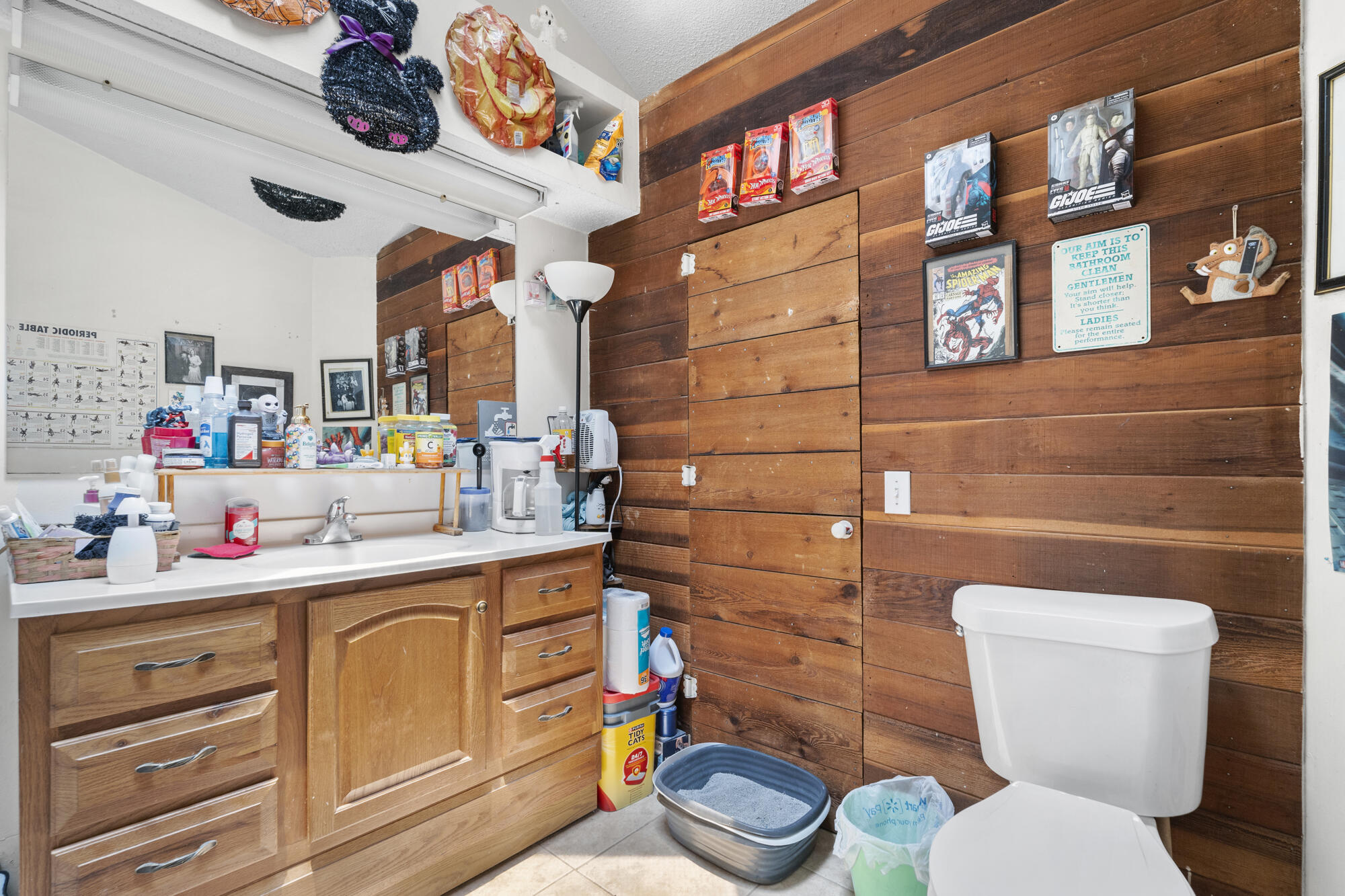 6904 Sea Turtle Circle Navarre, FL 32566 - Photo 19 of 49 a bathroom with a toilet sink and mirror