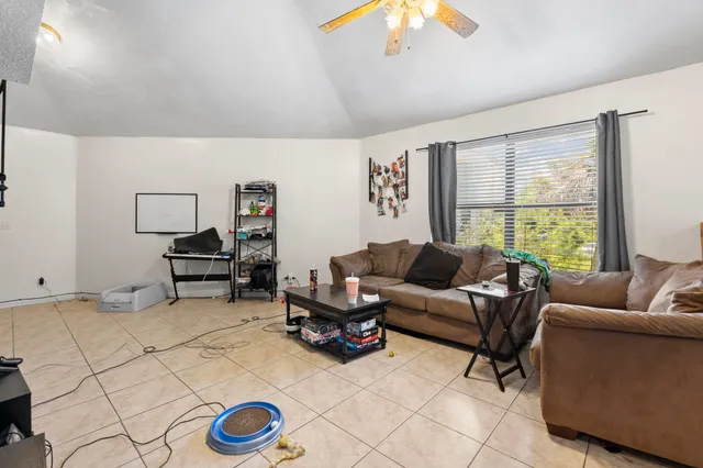 a living room with furniture gym equipment and a flat screen tv