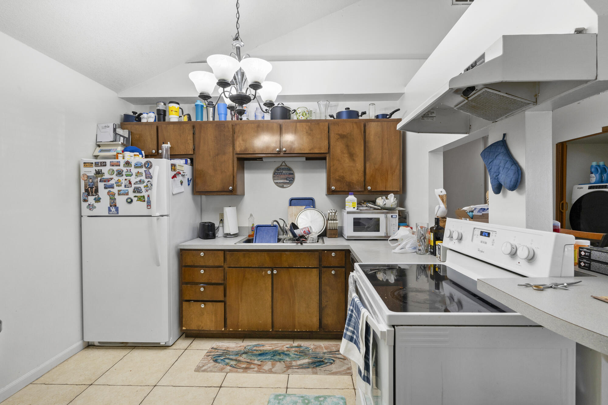 6904 Sea Turtle Circle Navarre, FL 32566 - Photo 28 of 49 a kitchen that has a lot of white cabinets and stainless steel appliances
