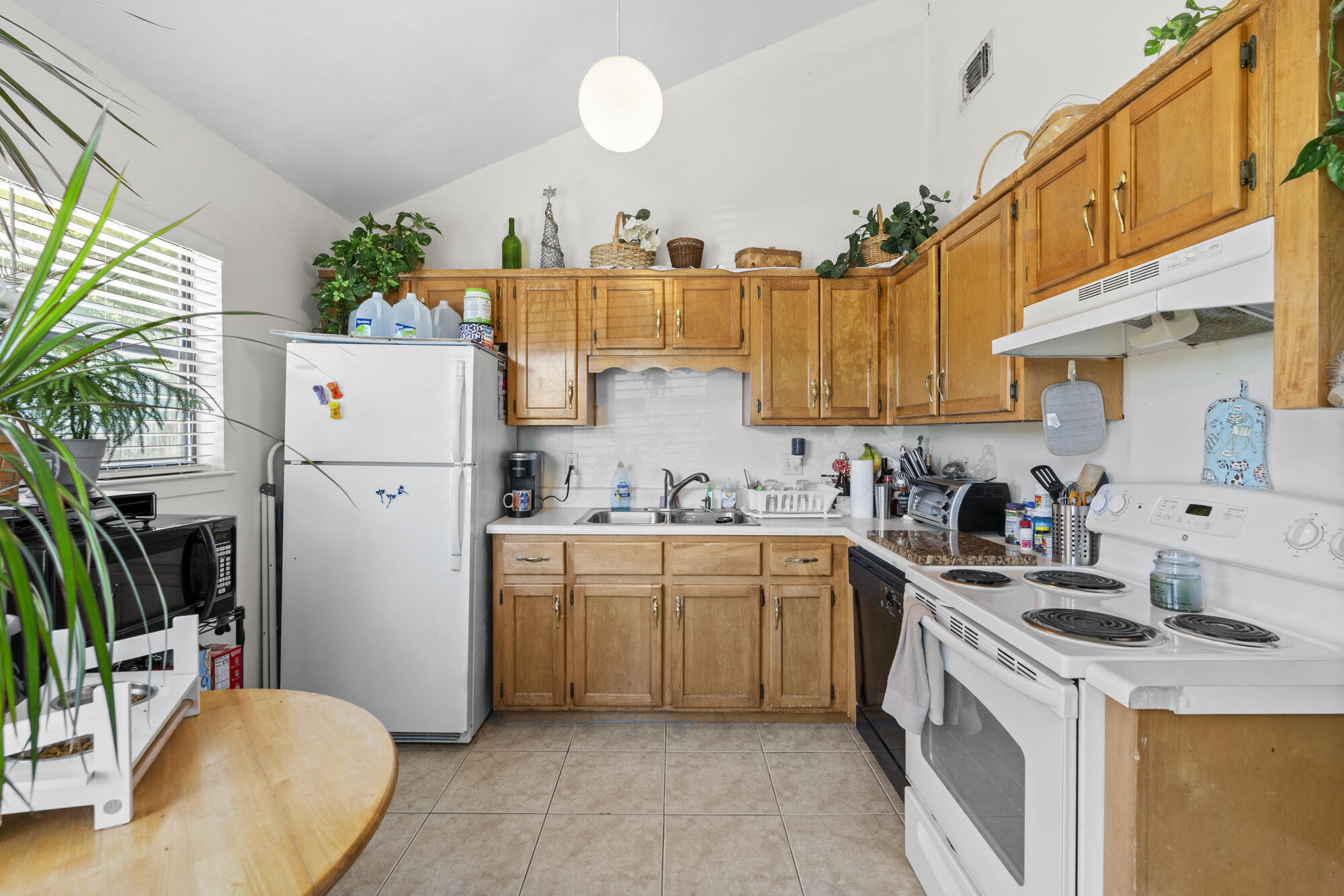 6904 Sea Turtle Circle Navarre, FL 32566 - Photo 39 of 49 a kitchen with a sink a refrigerator and a stove