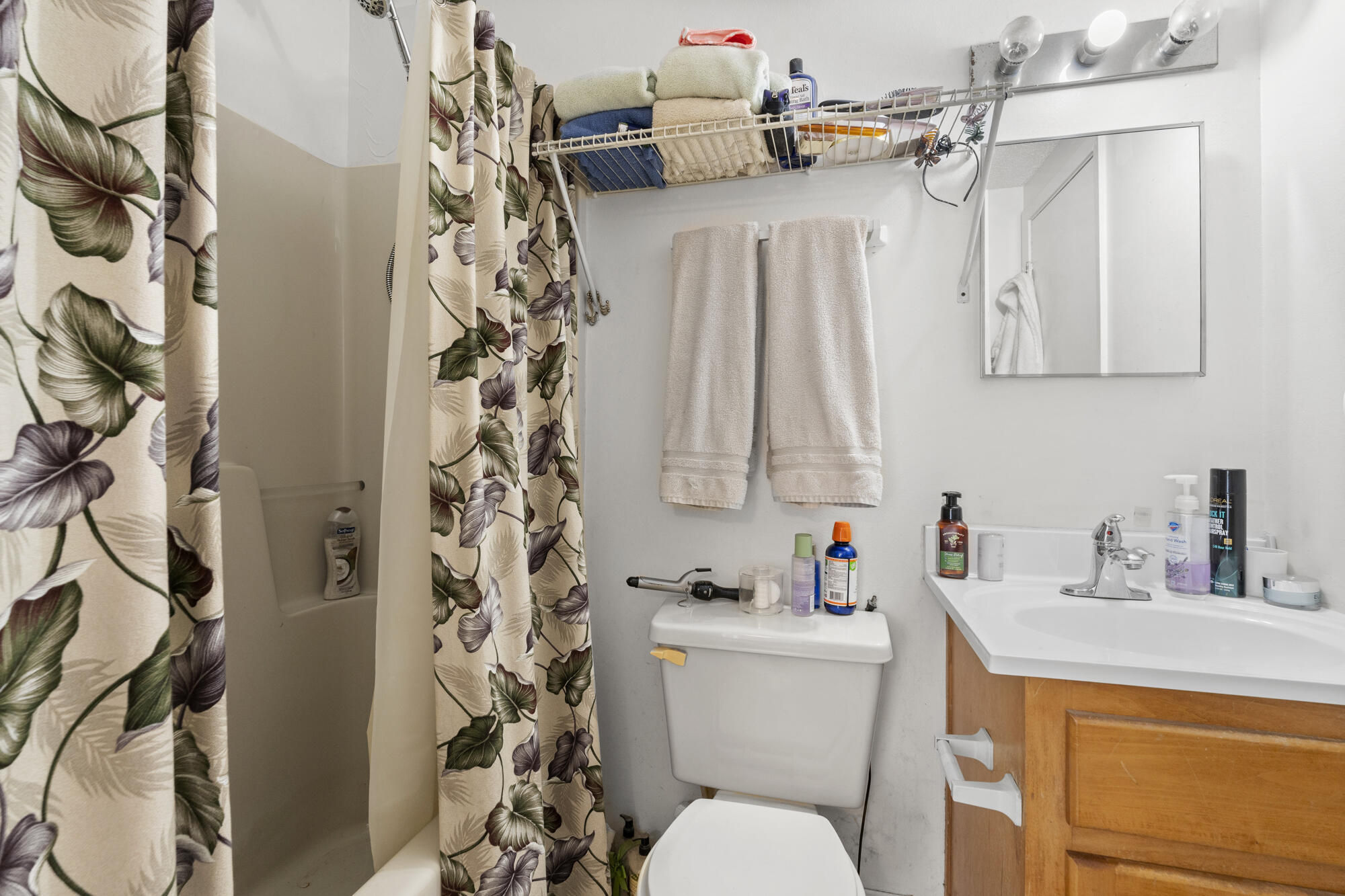 6904 Sea Turtle Circle Navarre, FL 32566 - Photo 43 of 49 a bathroom with a sink a toilet and a shower curtain