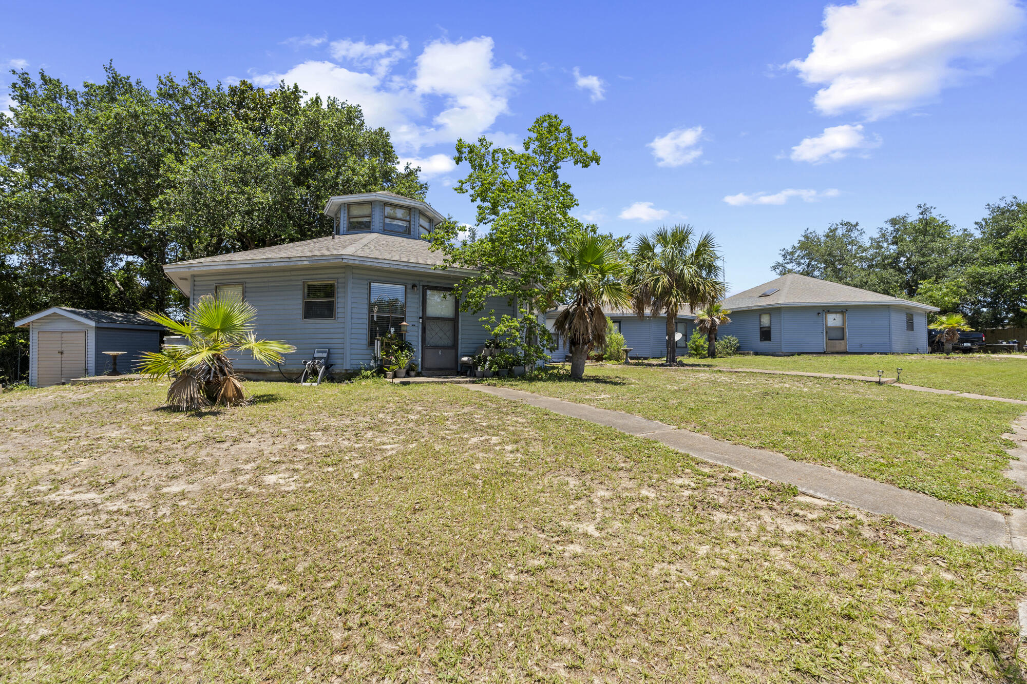 6904 Sea Turtle Circle Navarre, FL 32566 - Photo 45 of 49 a view of a house with garden and sitting area
