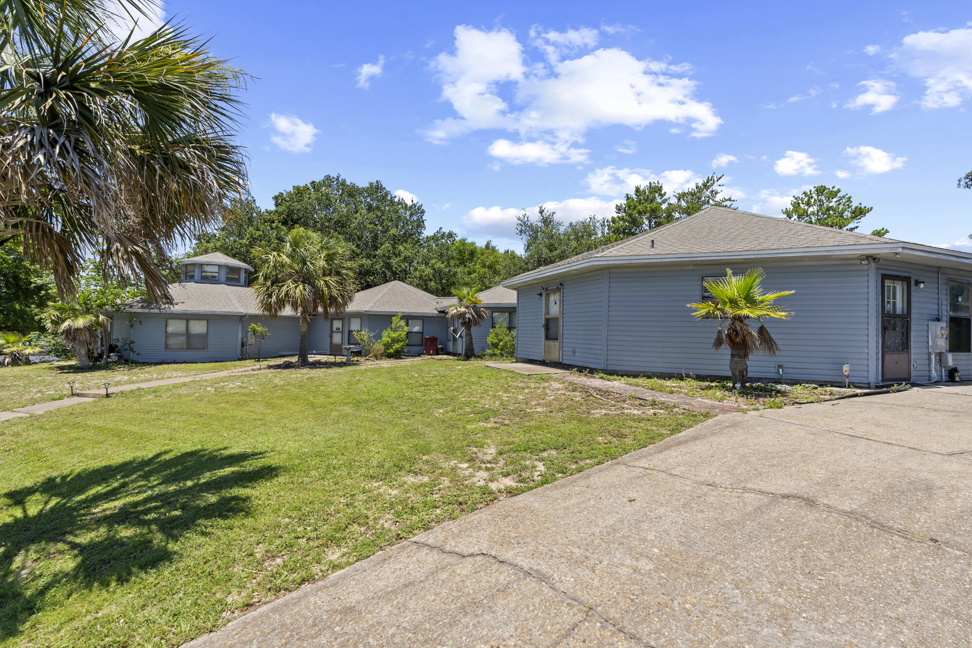 6904 Sea Turtle Circle Navarre, FL 32566 - Photo 47 of 49 a front view of house with yard and seating