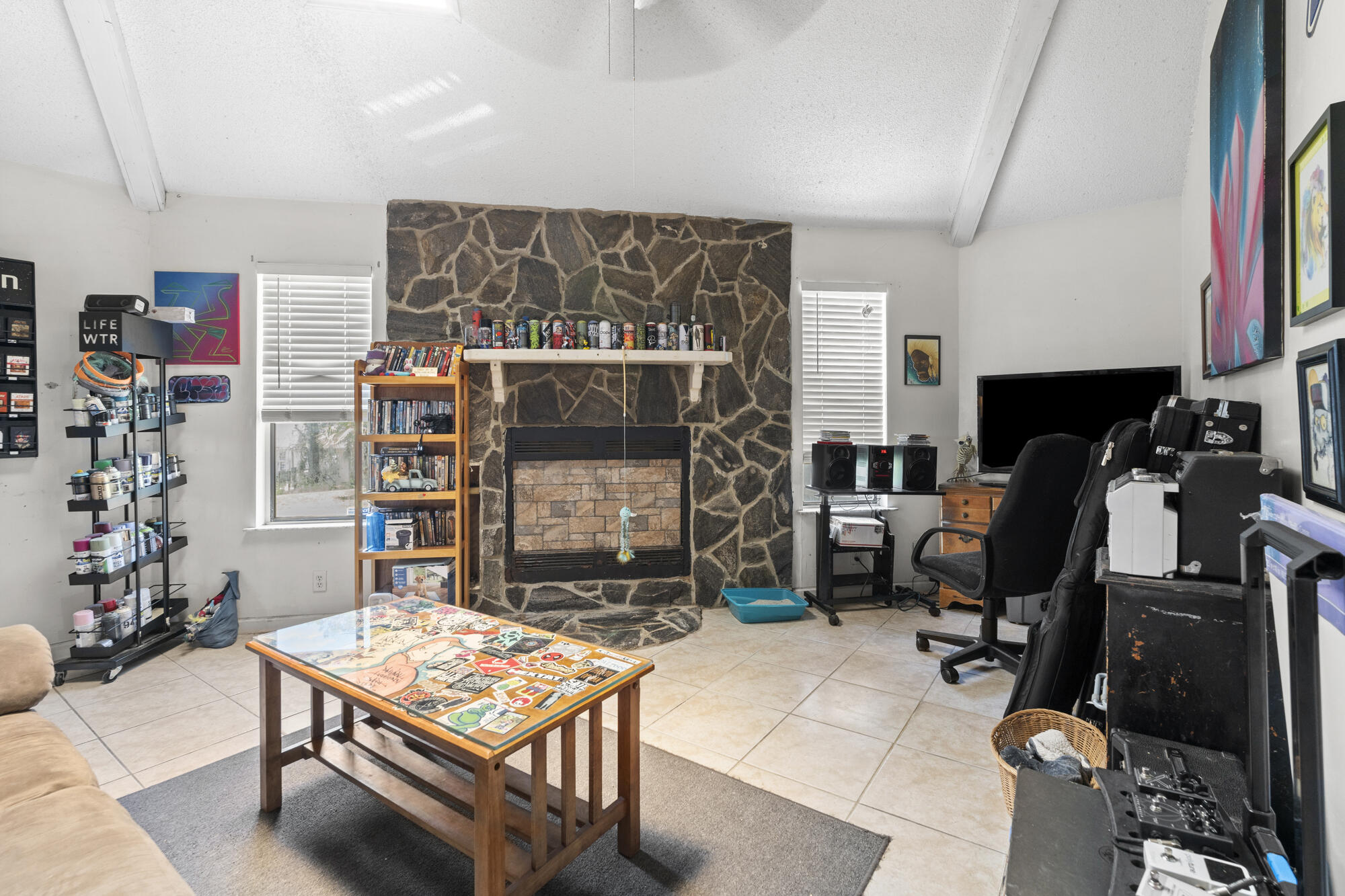 6904 Sea Turtle Circle Navarre, FL 32566 - Photo 6 of 49 a living room with furniture a flat screen tv and gym equipment