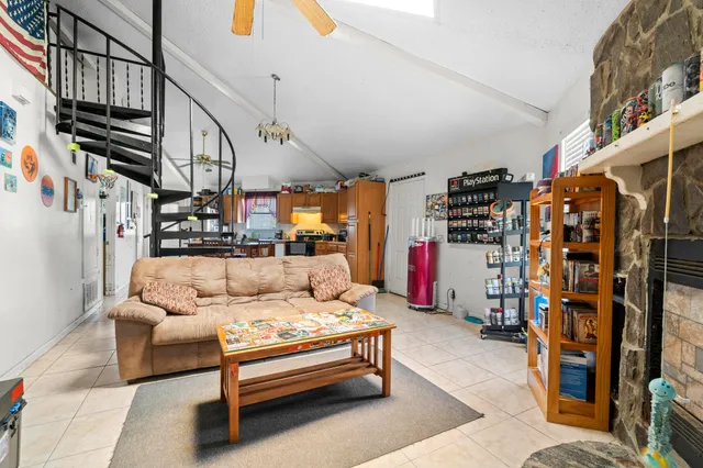a living room with furniture and a ceiling fan