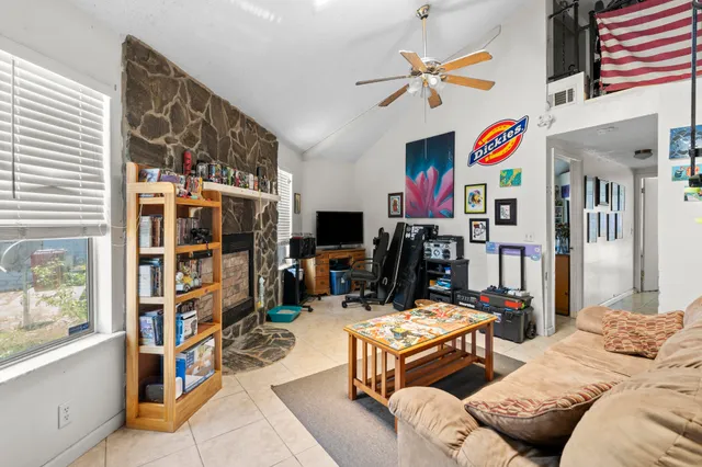 a living room with furniture a dining table and a window