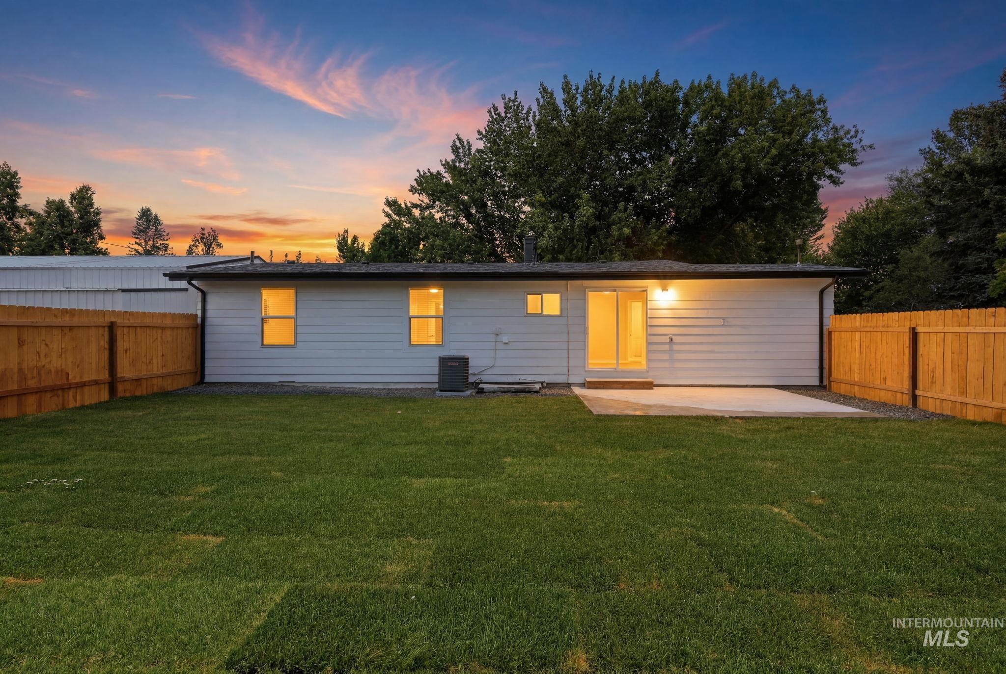 2152 Artesian Road Eagle, ID 83616 - Photo 48 of 50 Expansive backyard featuring a lush lawn and a newly installed wood privacy fence