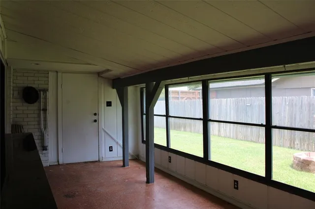 a view of an empty room with a large window