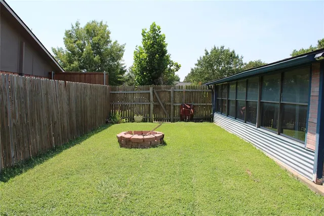 a view of a backyard with a large tree