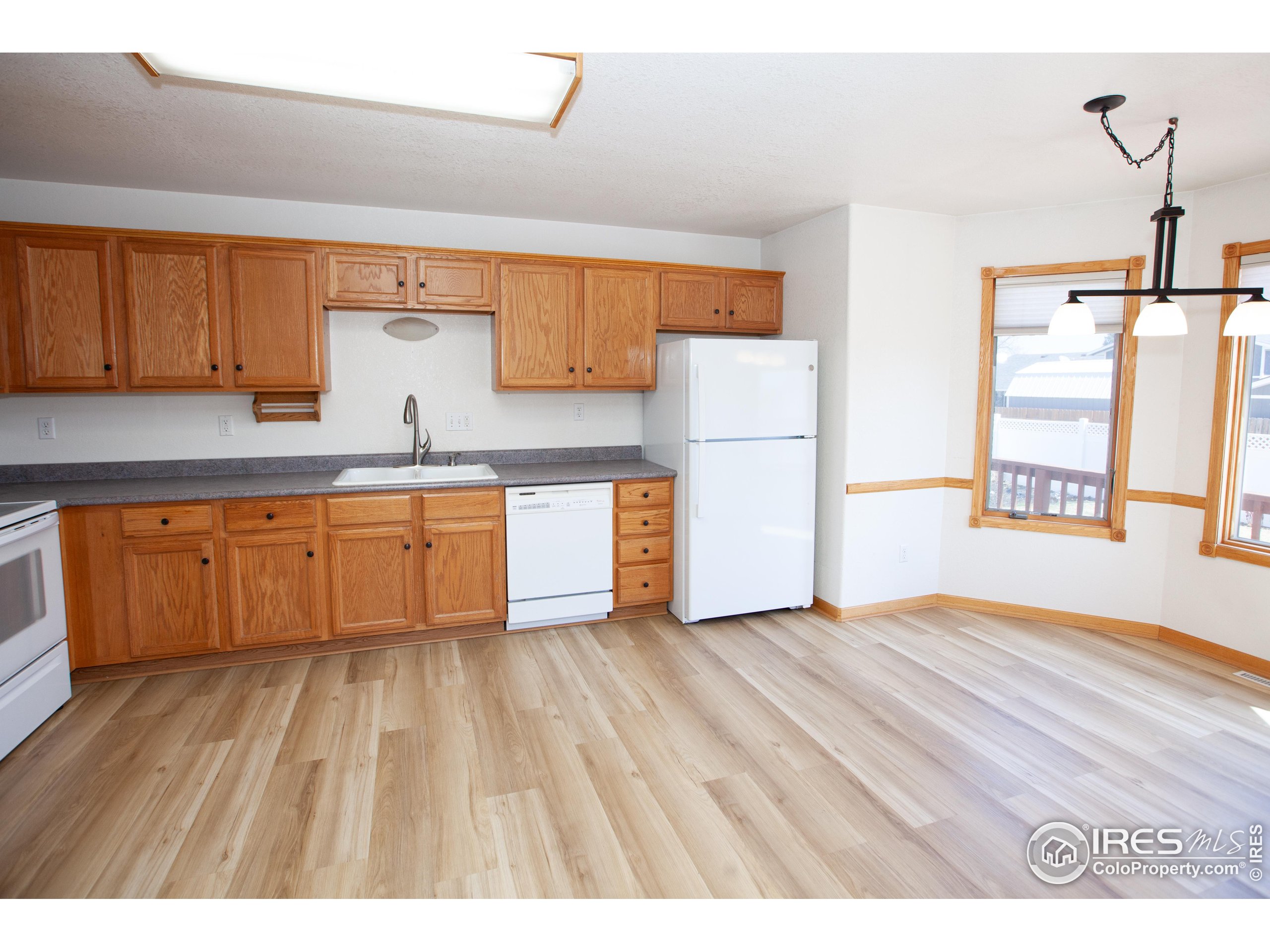 1815 Robin Road Sterling, CO 80751 - Photo 11 of 45 a view of kitchen with wooden floor and electronic appliances