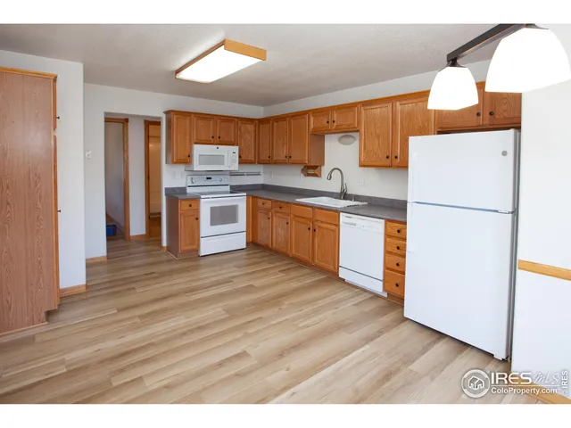 a kitchen with granite countertop a refrigerator and a stove