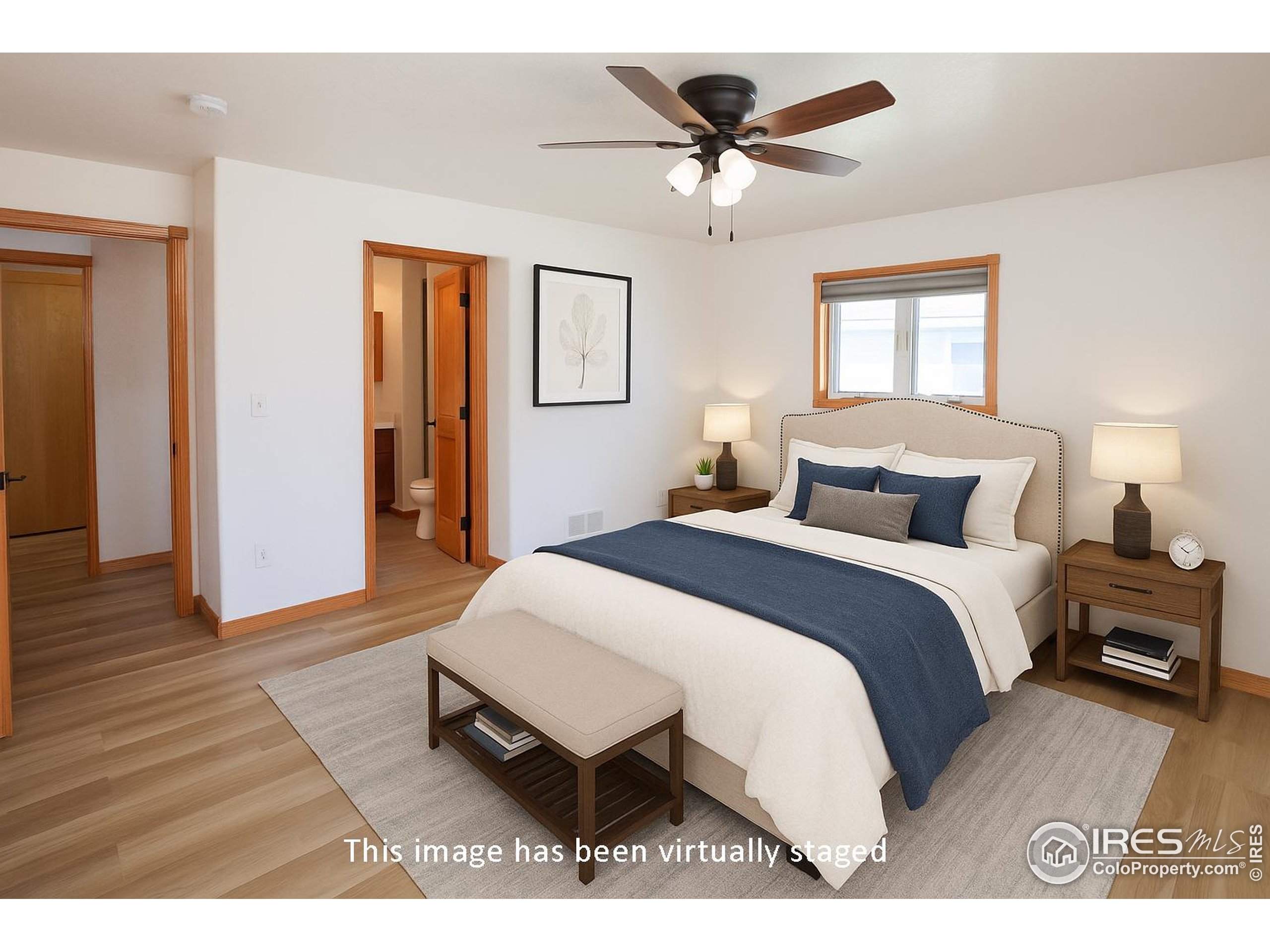 1815 Robin Road Sterling, CO 80751 - Photo 15 of 45 a bedroom with a bed and wooden floor