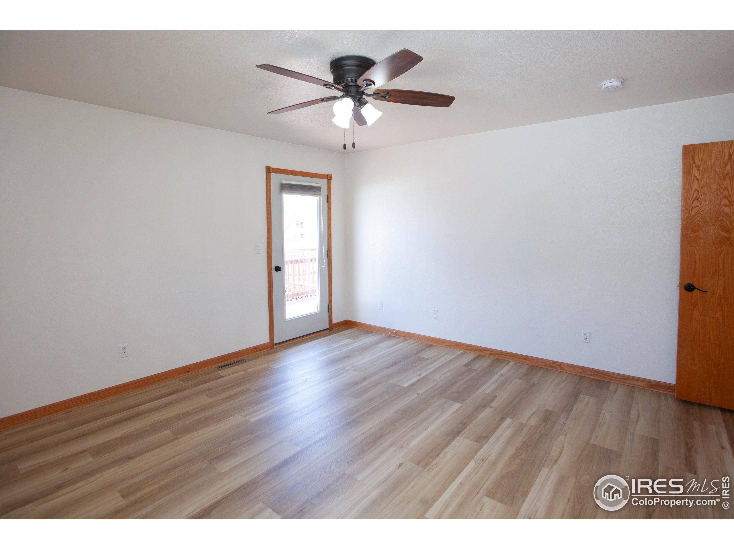 1815 Robin Road Sterling, CO 80751 - Photo 17 of 45 a view of an empty room with wooden floor