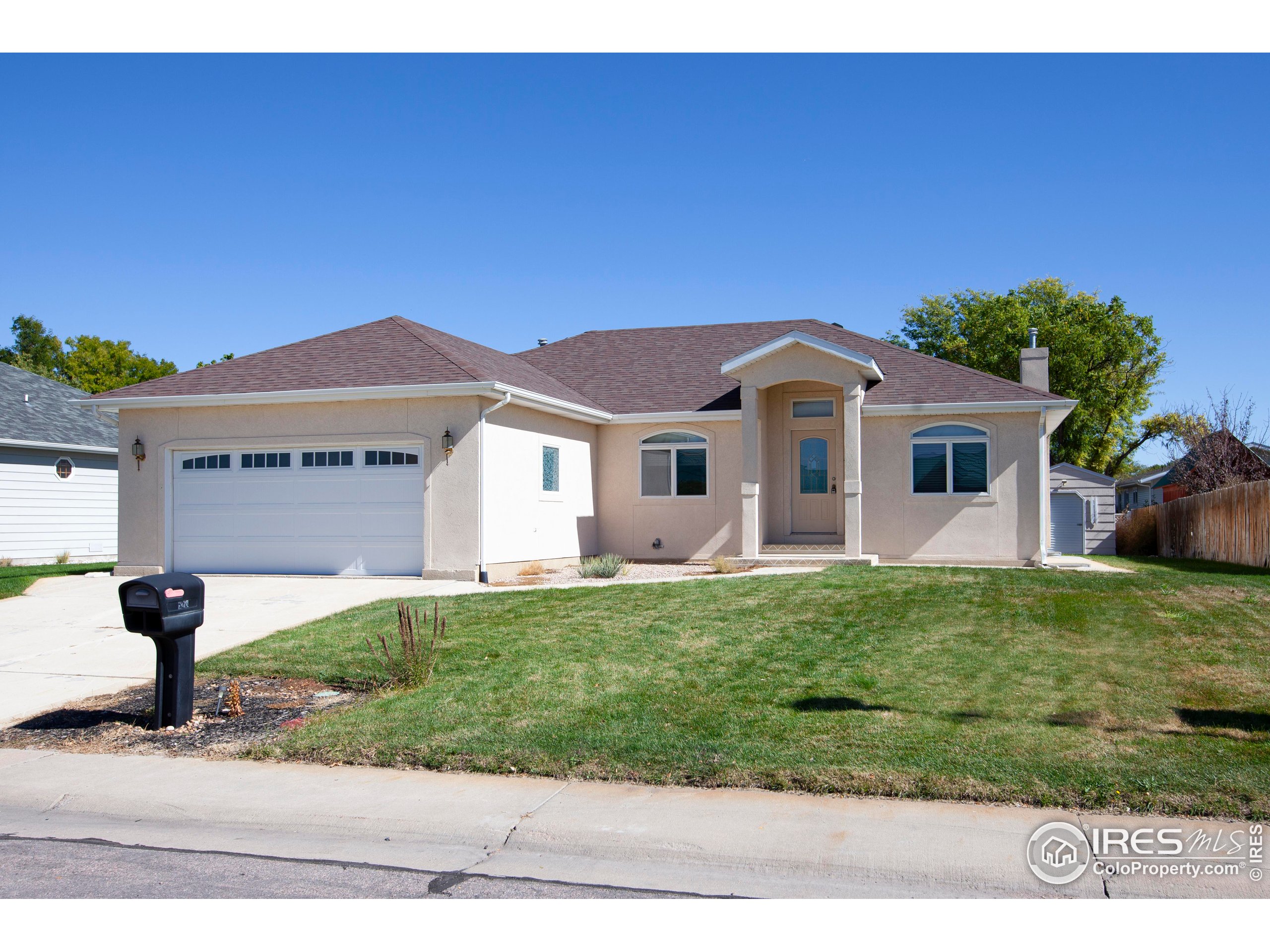 1815 Robin Road Sterling, CO 80751 - Photo 2 of 45 a front view of a house with a yard