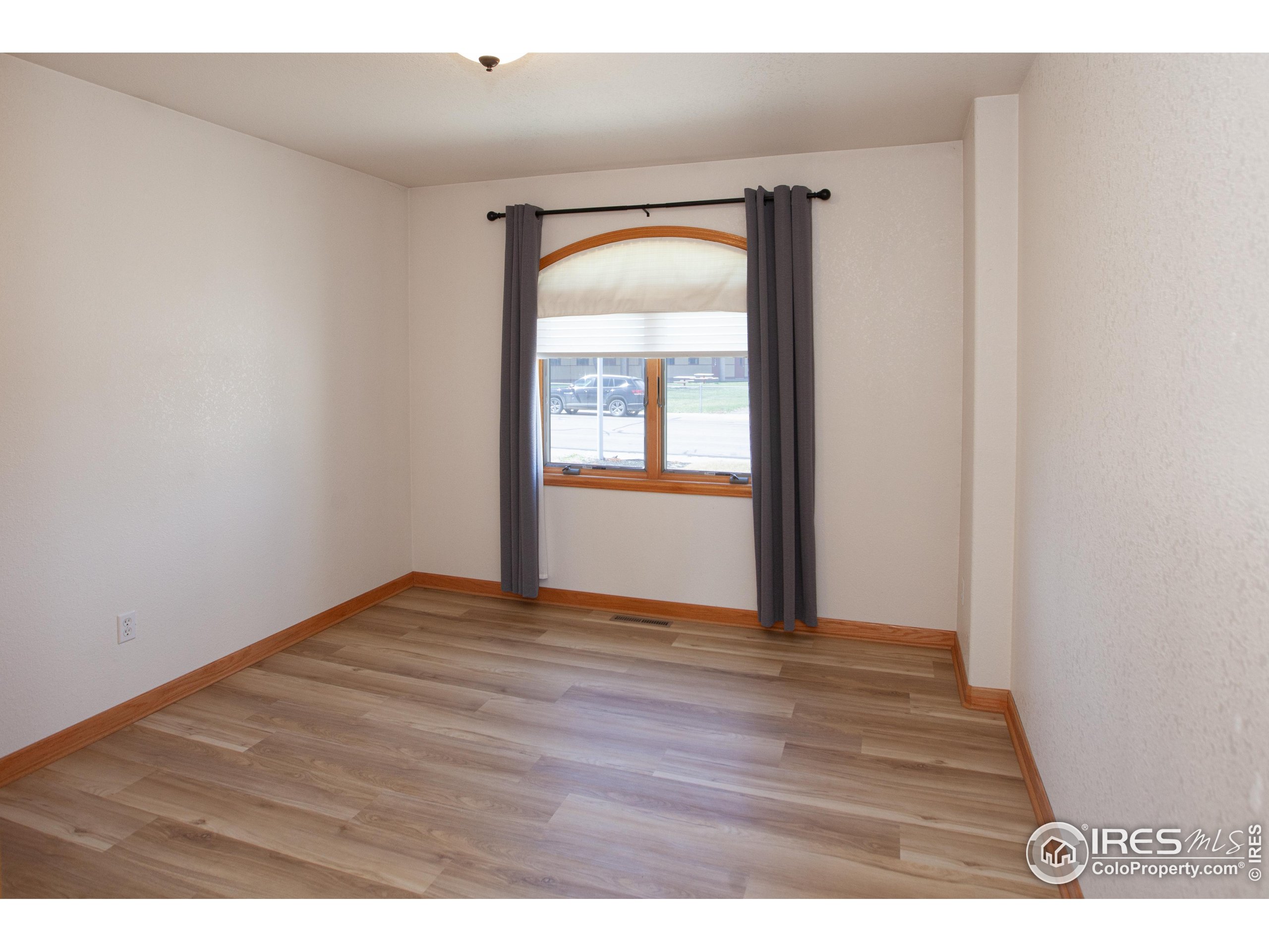 1815 Robin Road Sterling, CO 80751 - Photo 22 of 45 a view of empty room with wooden floor and fan