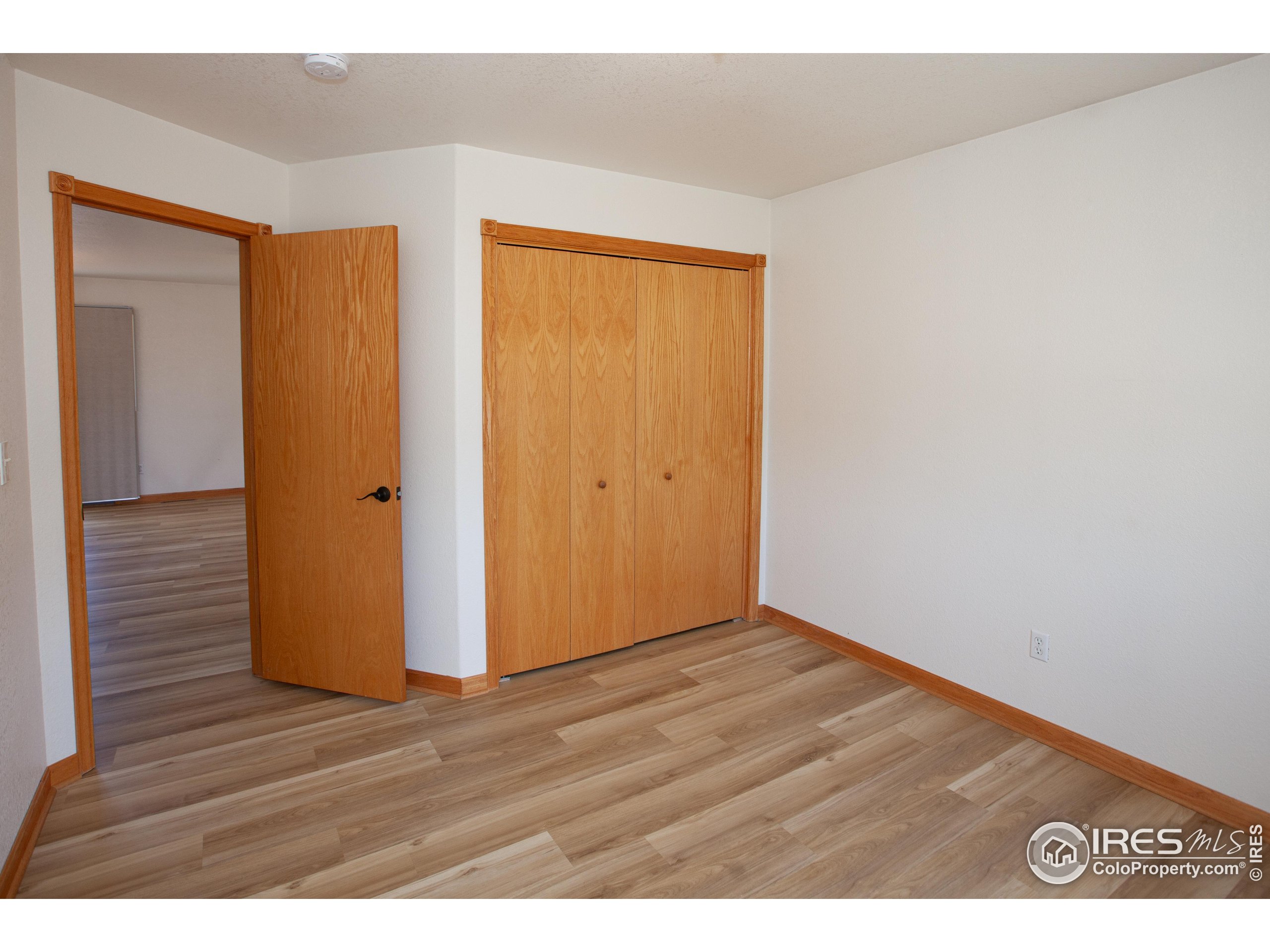 1815 Robin Road Sterling, CO 80751 - Photo 23 of 45 a view of an empty room with wooden floor