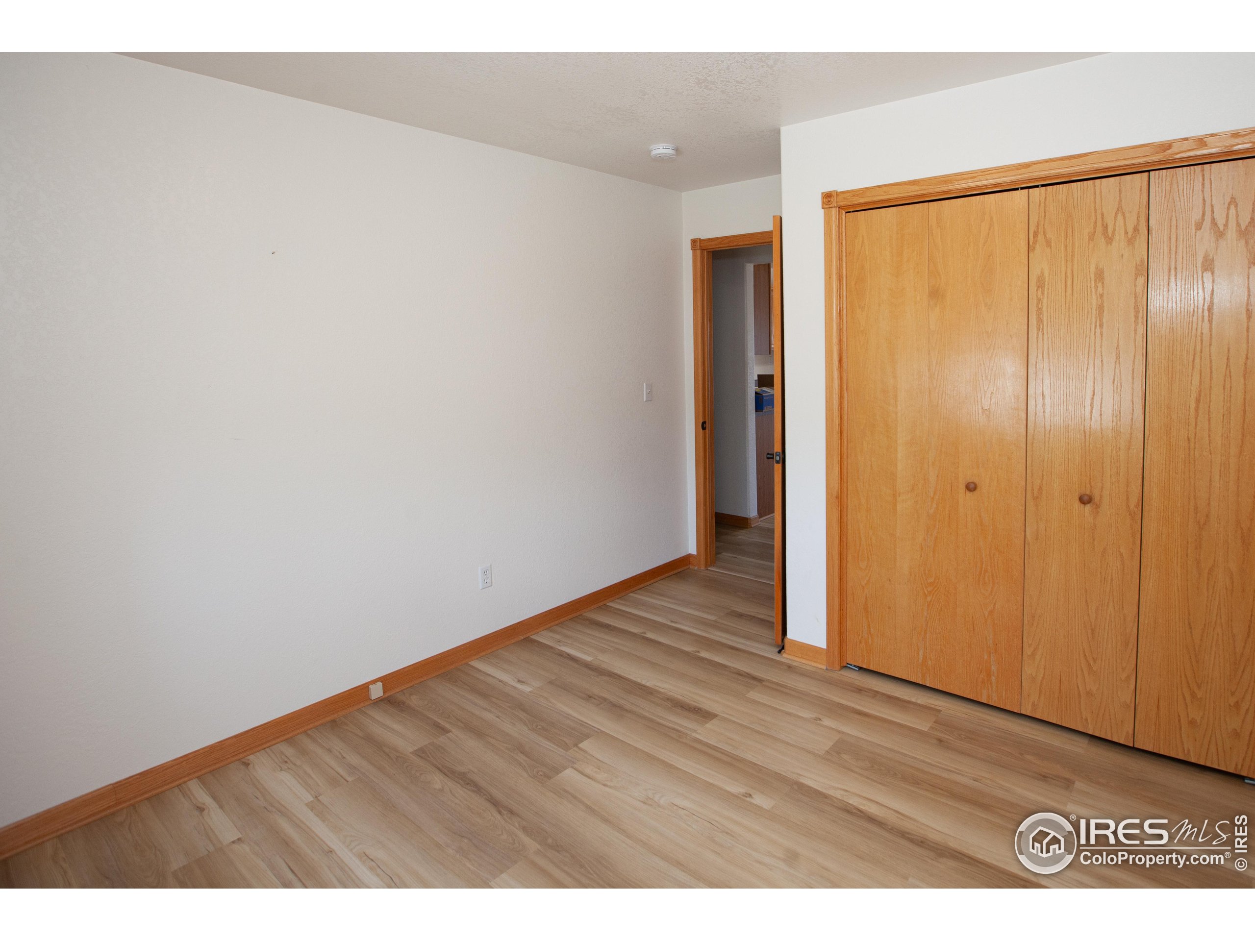 1815 Robin Road Sterling, CO 80751 - Photo 26 of 45 a view of an empty room with wooden floor