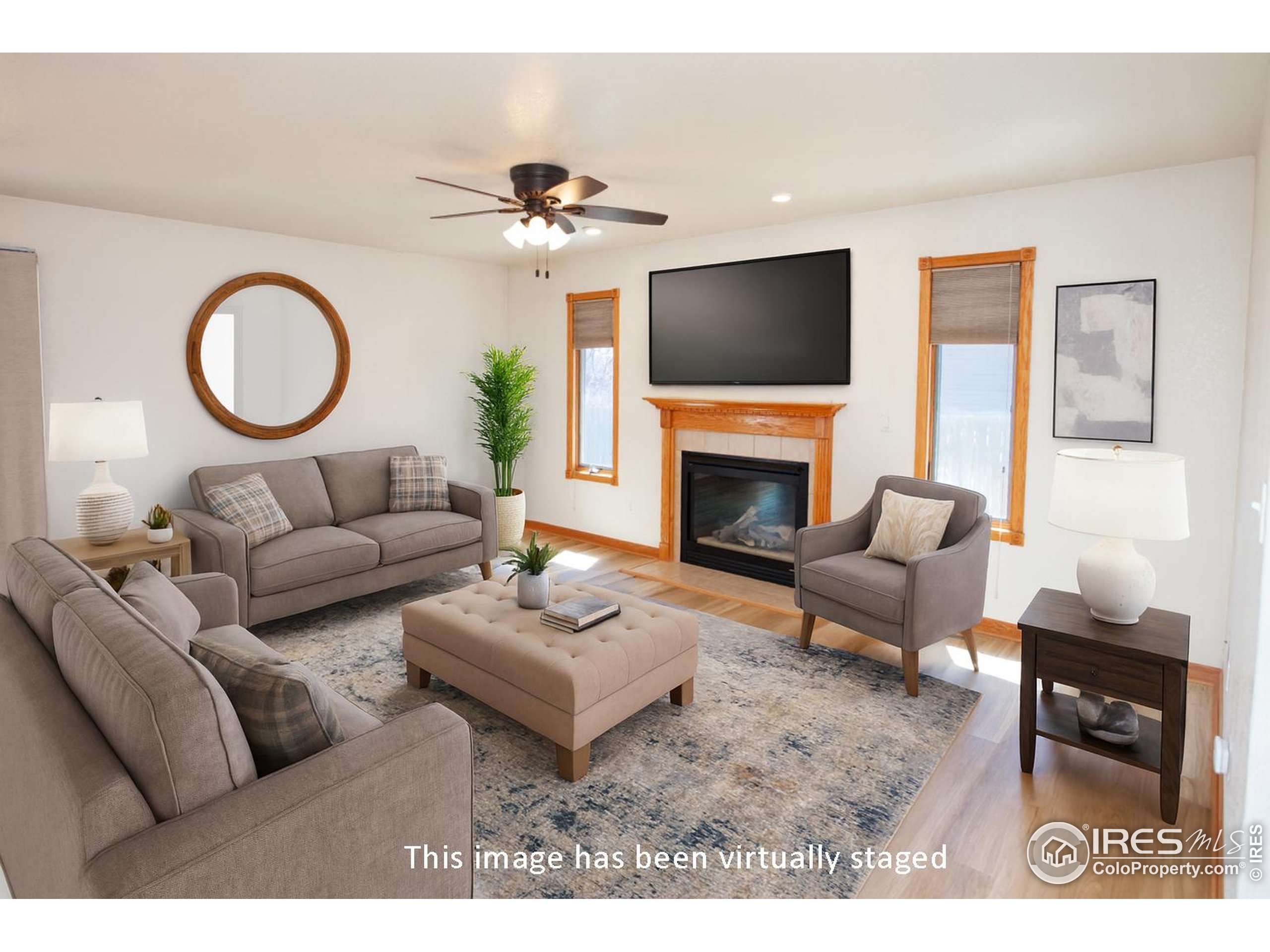 1815 Robin Road Sterling, CO 80751 - Photo 3 of 45 a living room with furniture a flat screen tv and a fireplace