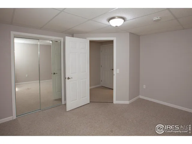 a bathroom with a granite countertop toilet sink and mirror