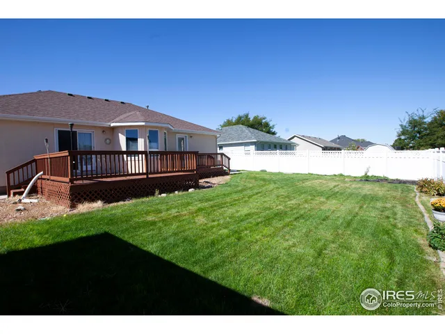 a view of a backyard with sitting area