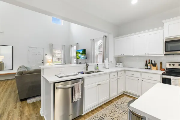 a kitchen with a sink a stove and cabinets